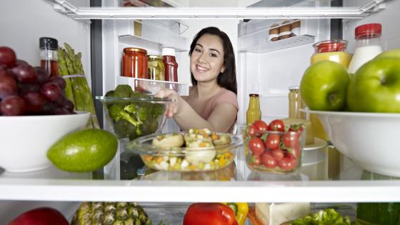 Woman Taking Broccoli From Fridge